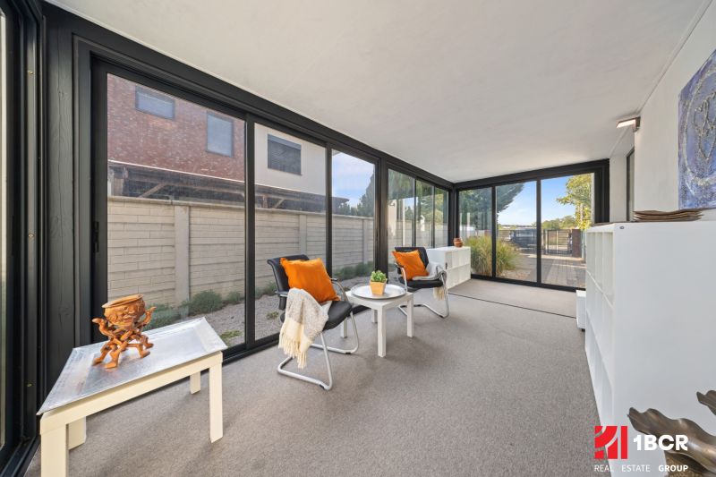 A glazed veranda with comfortable chairs and decorations in a 3-room apartment.