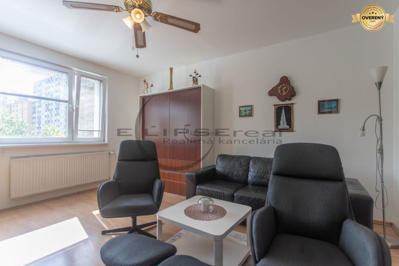 Living room with comfortable seating and wooden decor flooring in a 3-room apartment.