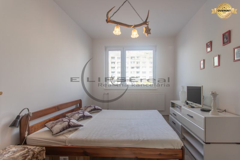 A bedroom with a double bed and light furniture in a 3-room apartment.