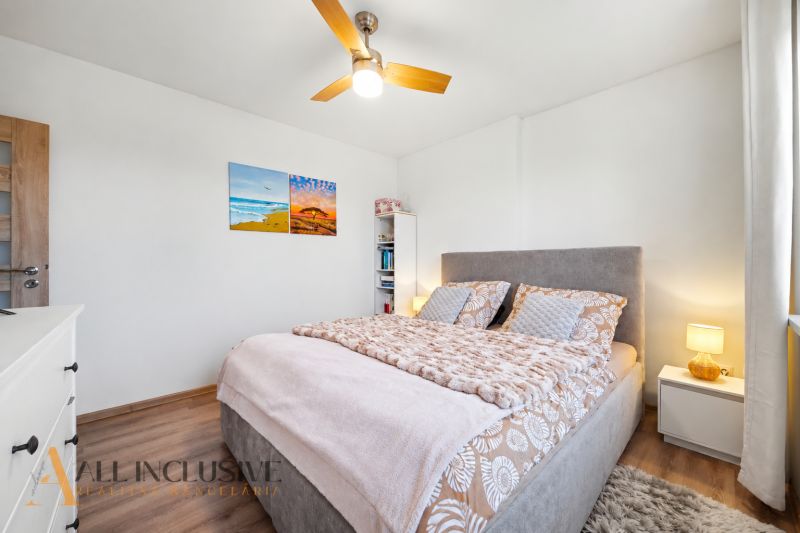 Bedroom in a family house with a bed and a wooden decor floor.