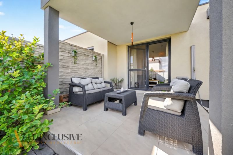 The terrace of a family house in Oľdza with garden seating and greenery.