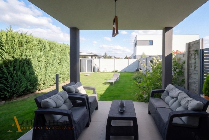 The terrace of a family house in Oľdza with comfortable seating and a view of the garden.