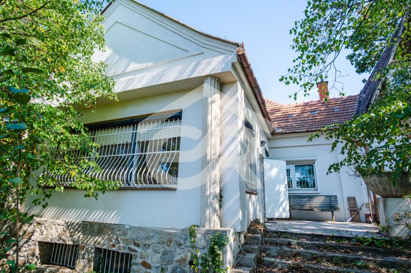 A family house on Chmeľová dolina in Nitra with a stone plinth and a terrace.