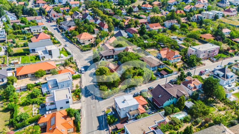 Aerial view of family houses on Chmeľová dolina street in Nitra, surrounded by greenery.
