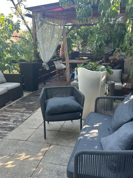 Garden terrace with comfortable seating and plants, ideal for relaxation in Bratislava.