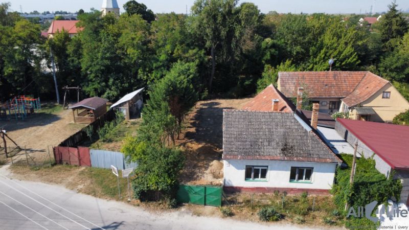 A family house on St. Florian Square, Krakovany, surrounded by greenery and a children's playground.