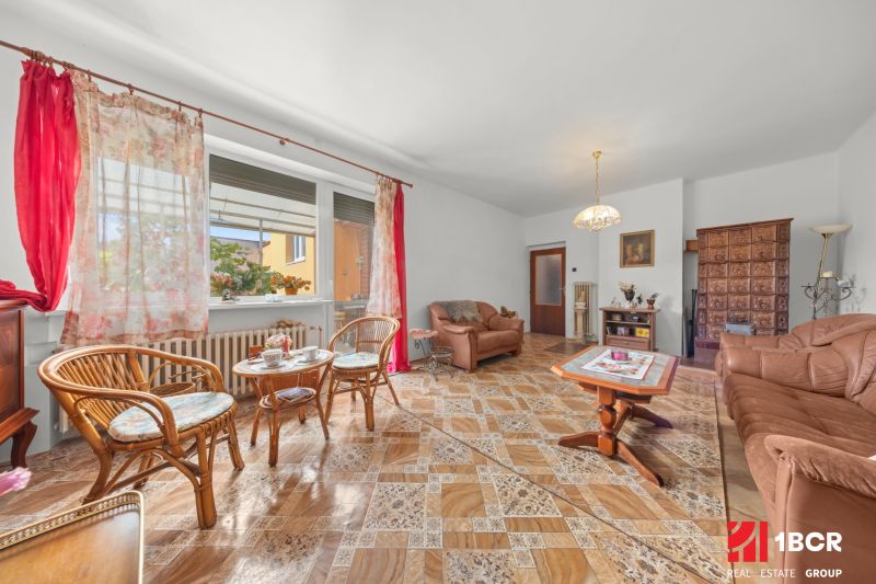 Living room in a family house with comfortable furniture and a wooden decor floor.