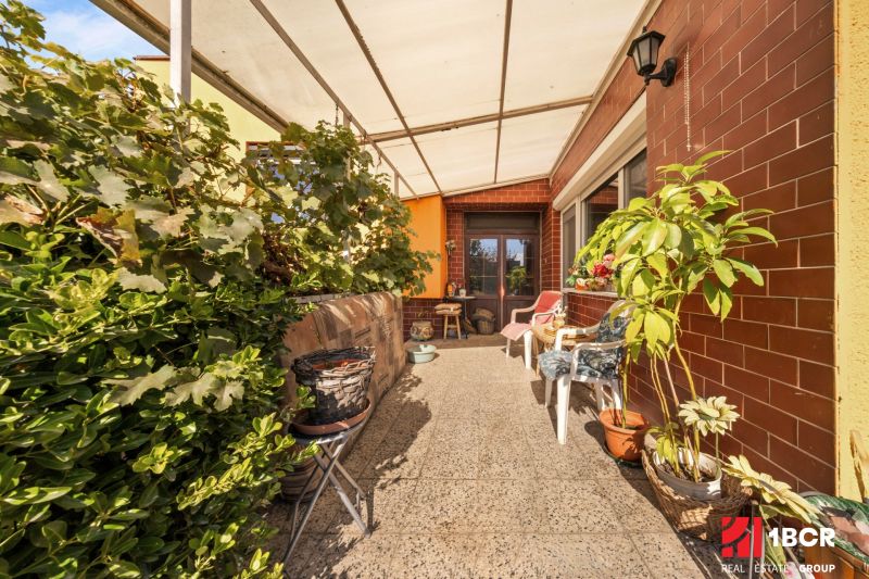Terrace at the family house on Lajos Kossuth Street in Dunajská Streda with plants and furniture.