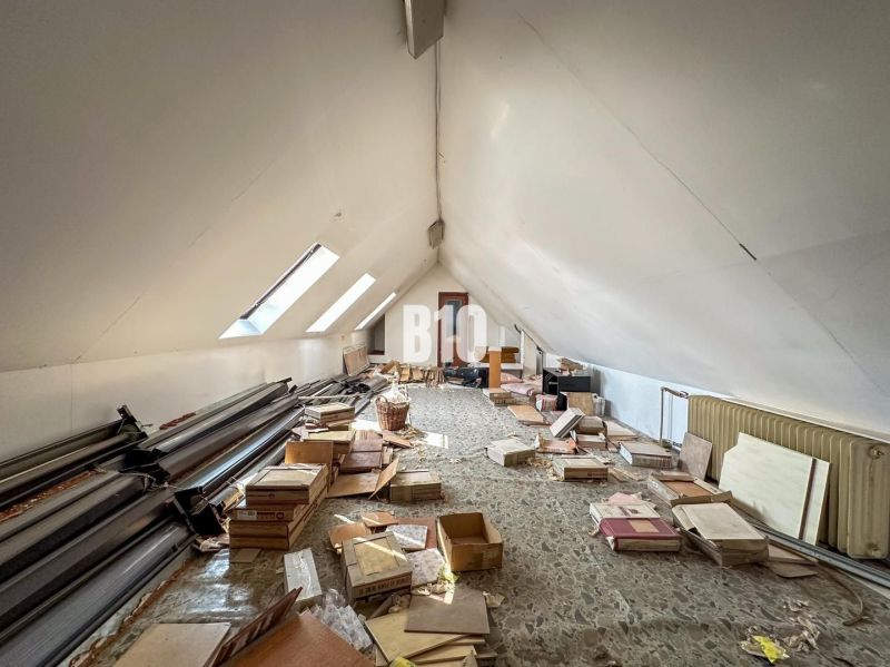 Attic with storage space and slanted roof windows in a family house.