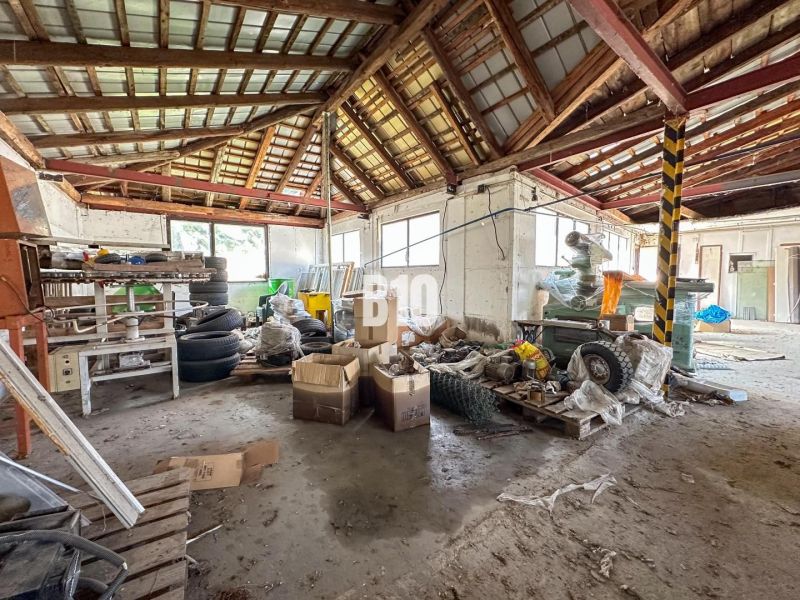 The interior of a family house with clutter and a lot of stored items and tires.