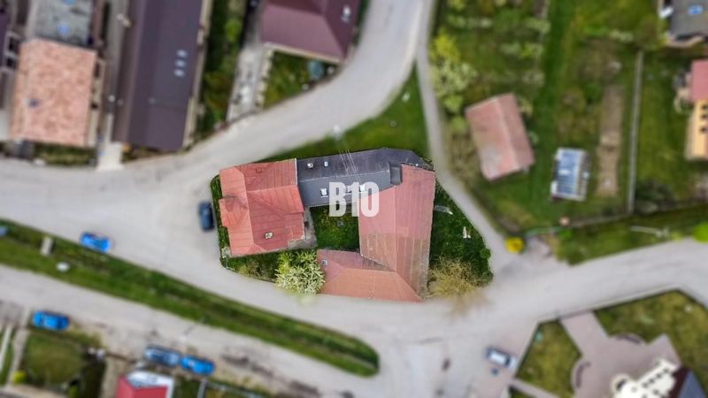 An aerial view of a family house in Púchov surrounded by roads and green areas.