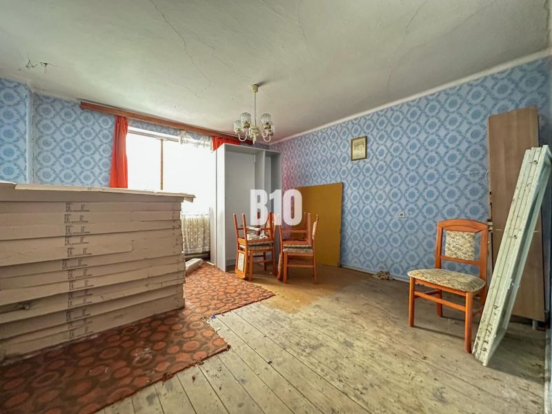 The interior of a family house with furniture and blue wallpaper on the walls.