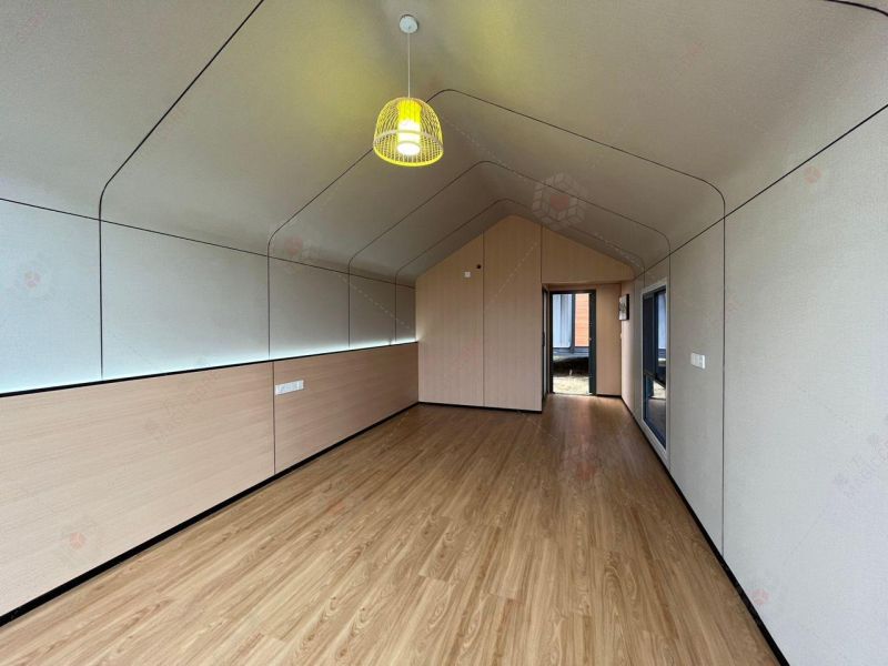 Interior of a cabin with a wood-patterned floor and an impressive pendant light.