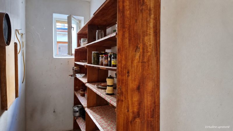 A pantry in a family house with shelves and stored preserves.