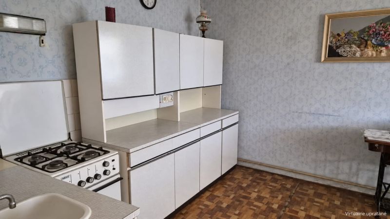 A kitchen in a family house with a gas stove and a wooden decor floor.
