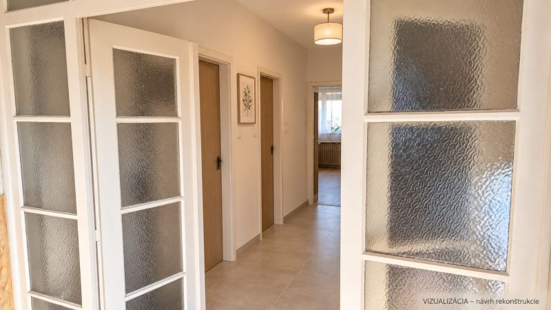 A hallway in a family house with glass doors and decorative elements.