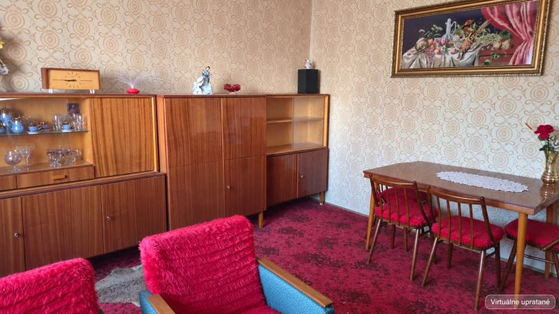 Living room of a family house with retro furniture, a red carpet, and wallpapered walls.
