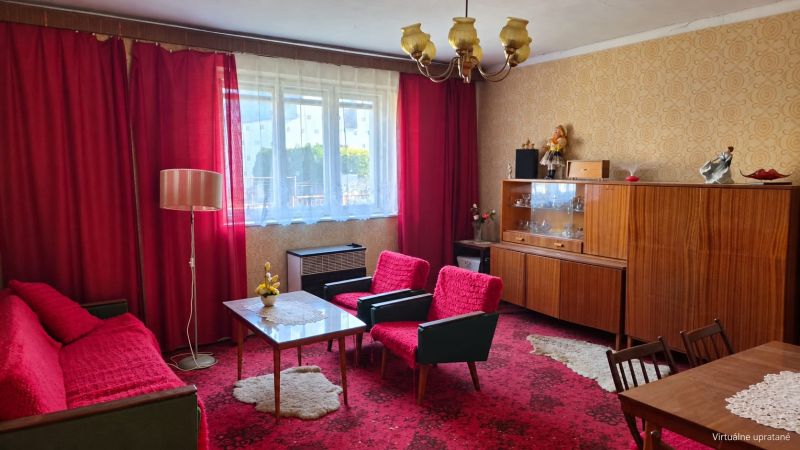 Living room in a family house with red curtains and vintage furniture.