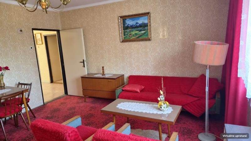 Living room in a family house with a red carpet and retro furniture.