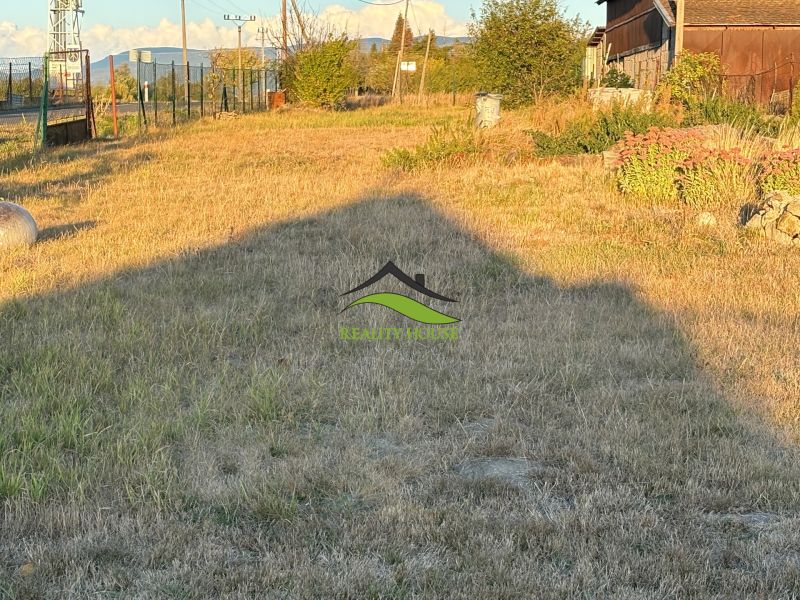 A garden at a family house in Blatné Revištia with grass cover and the sky in the background.