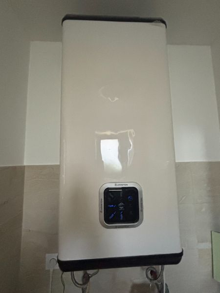 Electric boiler in a family house with touch control and digital display.