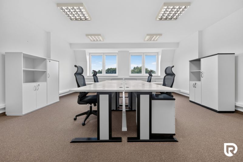 Spacious offices with desks, black chairs, and storage cabinets, floor with wood decor.
