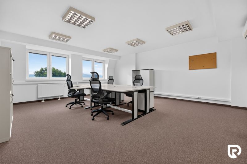 Offices with rolling chairs, white desks, and a bulletin board, floor with wood decor.