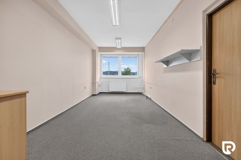 Offices with carpet, white walls, and a window, ideal for a workspace.