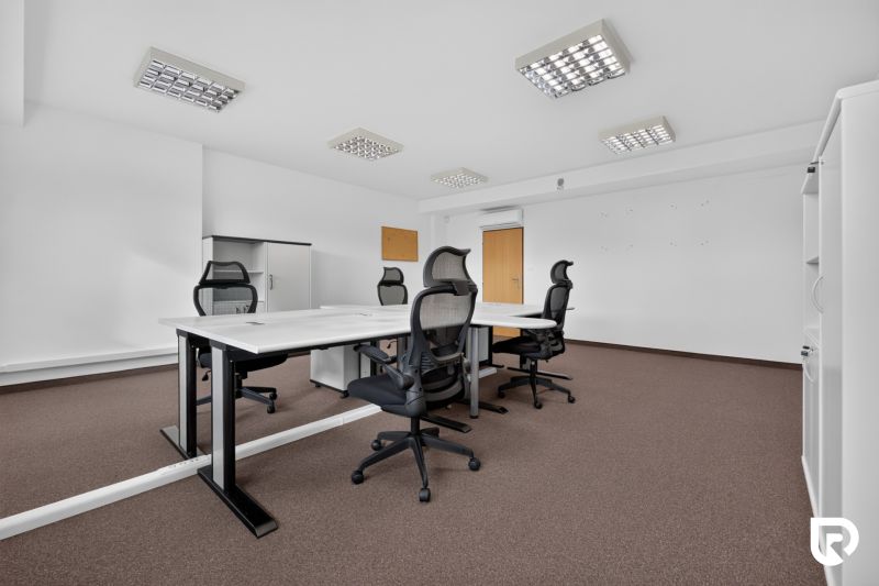 Offices with a conference table, ergonomic chairs, and storage cabinets.