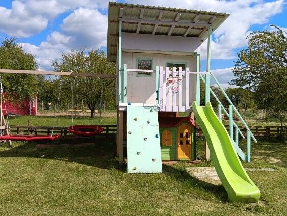 Children's playground with a slide in the garden at Tatranská 201 in Zlaté Moravce.