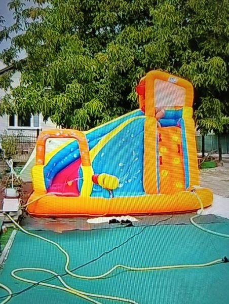 Inflatable attraction in the garden in Zlaté Moravce with a swing and a slide.