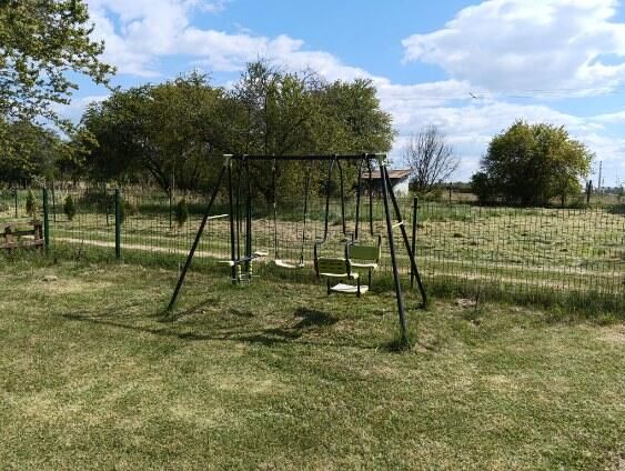 A children's swing in the middle of the garden at Tatranská 201 in Zlaté Moravce.