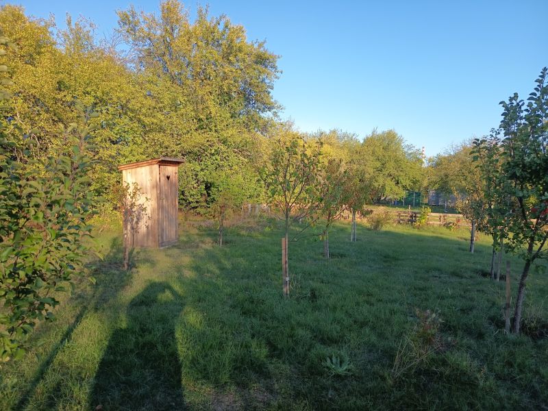 Gardens at Tatranská 201 in Zlaté Moravce with a wooden shelter surrounded by trees.