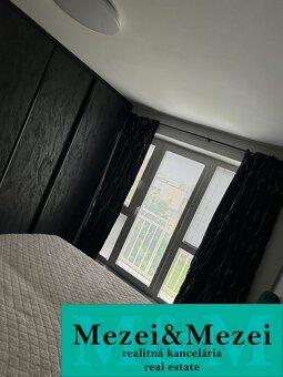 Bedroom in a 2-room apartment with a bed and a window, verified real estate agency.
