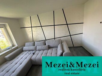 Interior of a 2-room apartment with a comfortable sofa and a floor with a wooden decor.