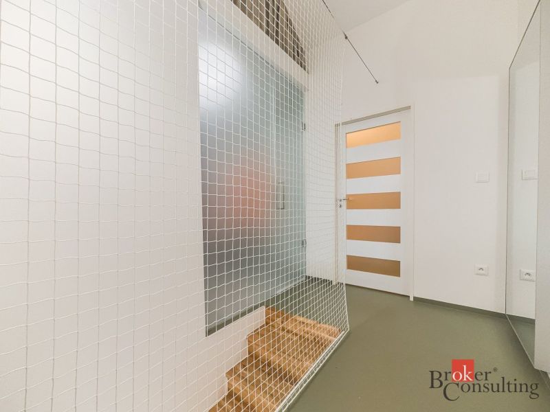 A hallway with a decorative net and two doors in a 3-room apartment.