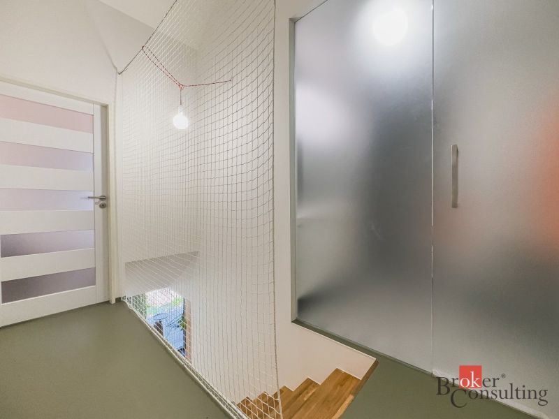 Glass doors, mesh railing, and wooden stairs in a 3-room apartment.