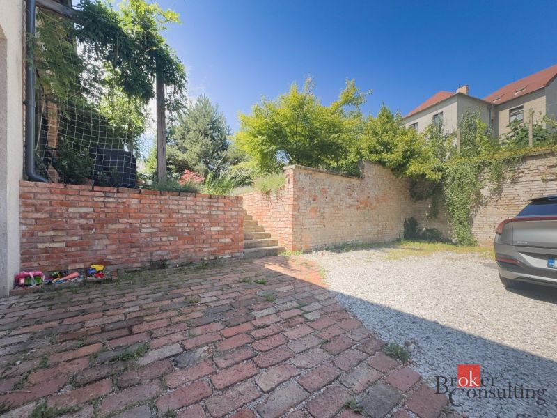 The exterior of a 3-room apartment on Čajakova Street in Bratislava-New Town with a brick fence.