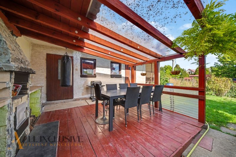 In Trstice, a family house with a terrace, table, chairs, and a fireplace for grilling.