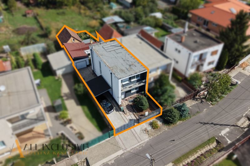 A family house in Trstice in an aerial photograph, with marked property boundaries.