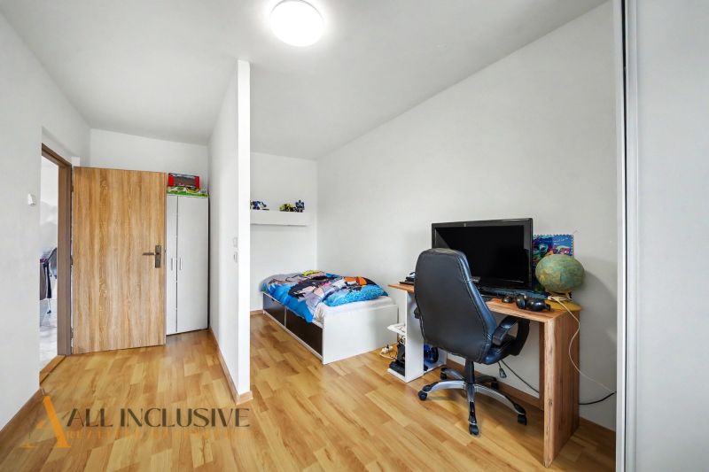 Children's room in a family house with a desk and a wooden decor floor.