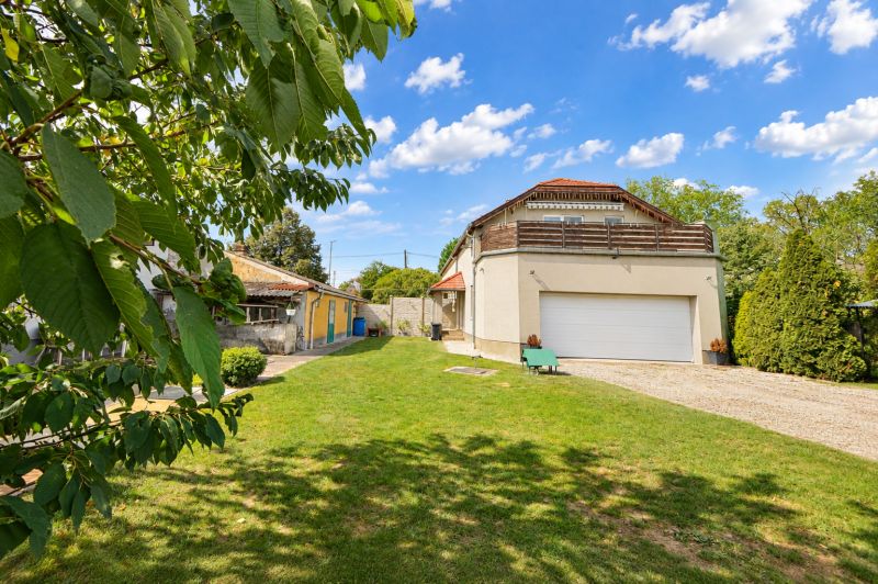 A family house in Mosonmagyaróvár with a large garden and garage, surrounded by greenery.