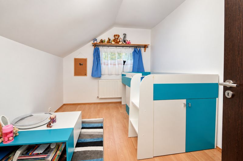 A children's room in a family house with blue decorations and a wooden decor floor.