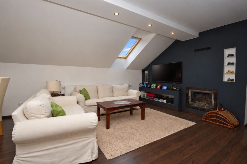 Living room in a family house with a fireplace, sofas, and a wooden decor floor.