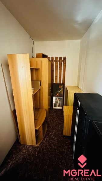 Storage room with wooden decor, shelves, and cabinets in a 3-room apartment.