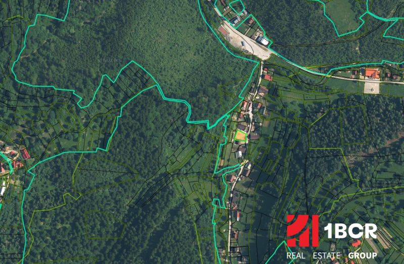 Aerial view of land plots in the Oščadnica area with visible parcels and roads.