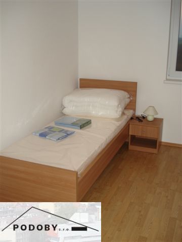 Single bed with a wooden floor decor in a 3-room apartment.