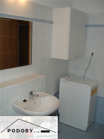 Bathroom in a 3-room apartment with a sink and a washing machine.