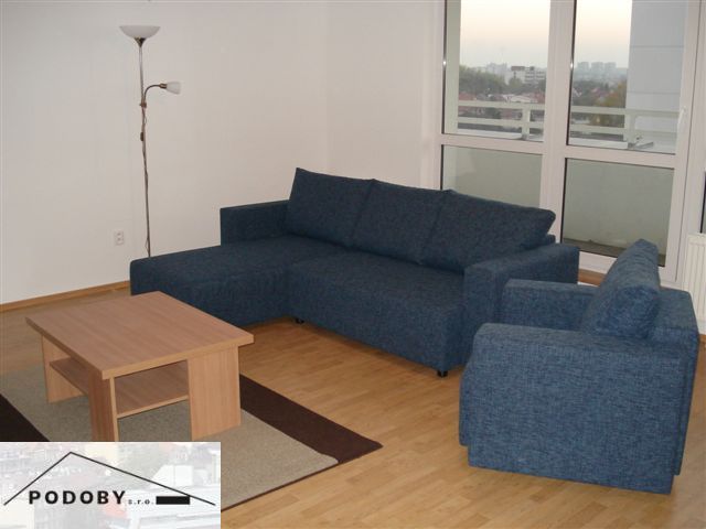 Living room with a sofa and a table in a 3-room apartment.