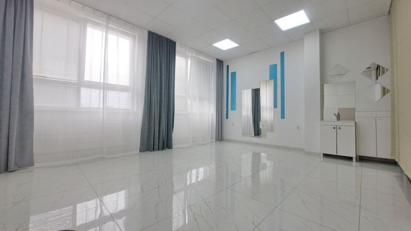 Bright commercial spaces with large windows and mirrors.